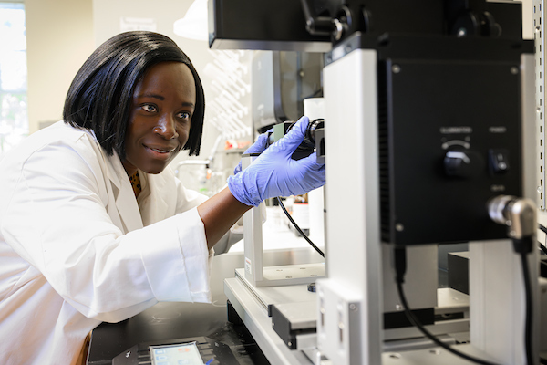 researcher in a lab working with equipment