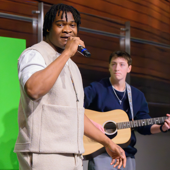 singer and guitarist performing at CreativeShowcase event