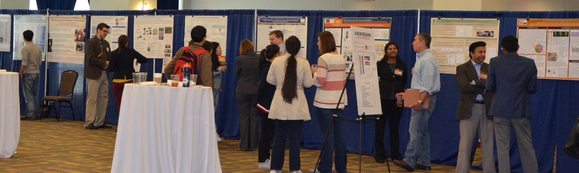 symposium attendees looking at booths