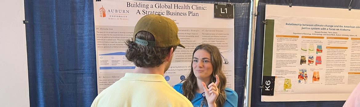 two people discussing research standing in front of display