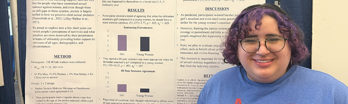 student standing in front of research display