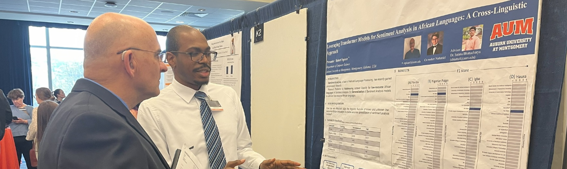 student explaining research display to attendee