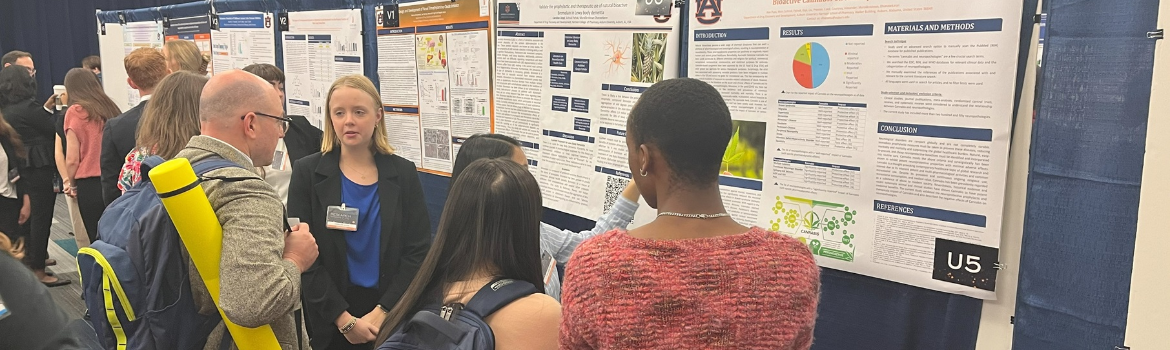 group of people looking at research displays and speaking with researchers
