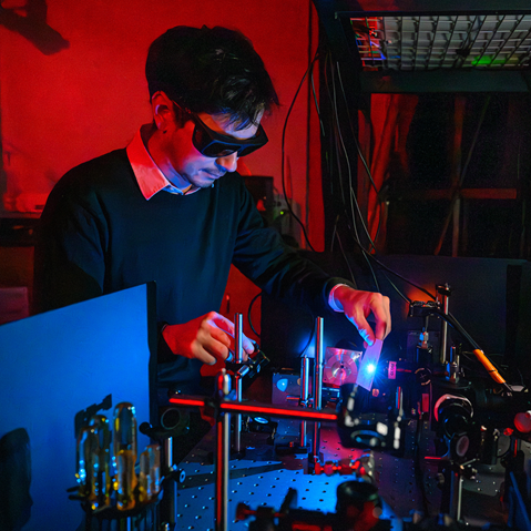 Paul Ohno demonstrating laser equipment for studying airborne viruses
