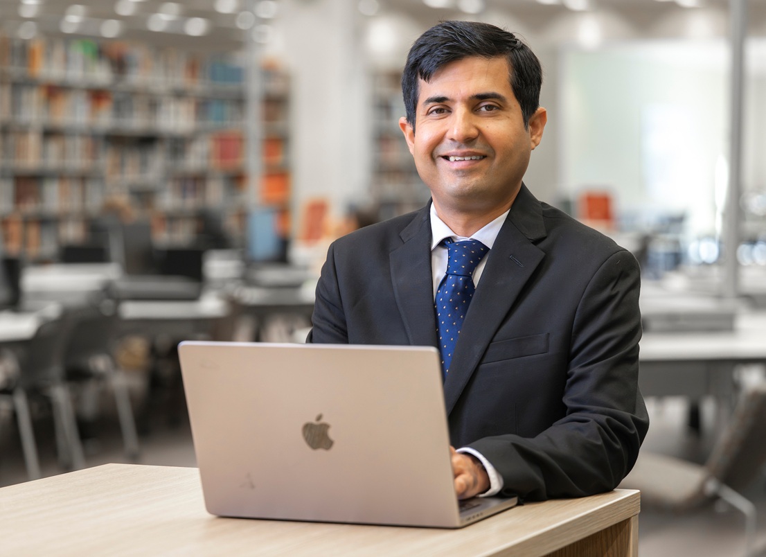 Sayyed Fawad Ali Shad in library with laptop computer