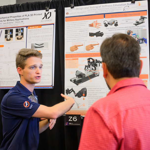 student giving poster presentation at 2025 Research Symposium