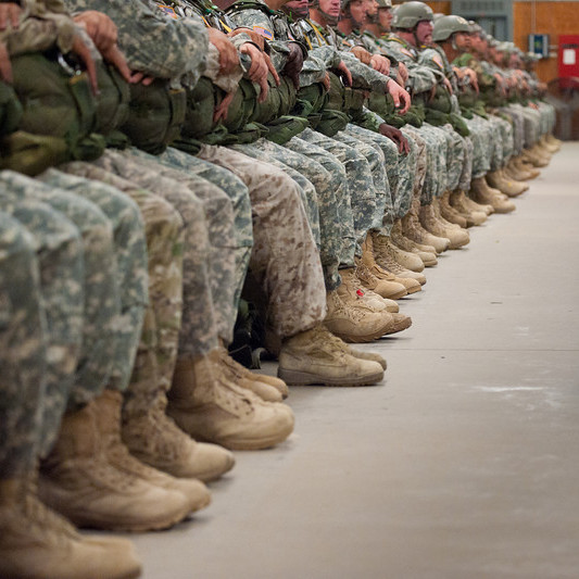 members of military seated in a row