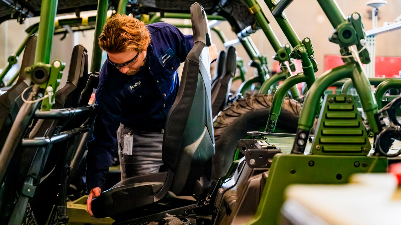 engineer assembling a vehicle in the advanced manufacturing lab