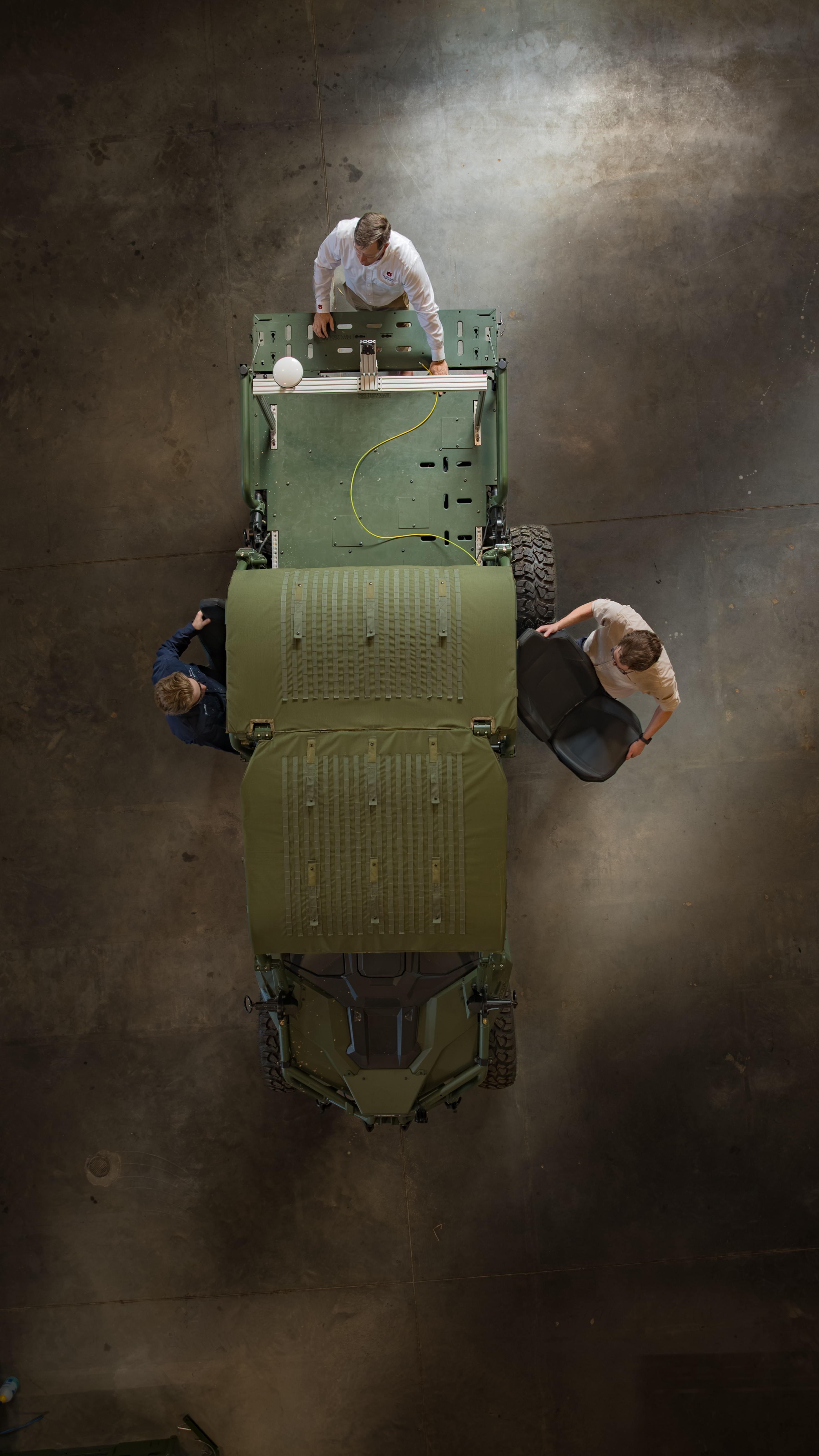 overhead view of engineers working on a vehicle 