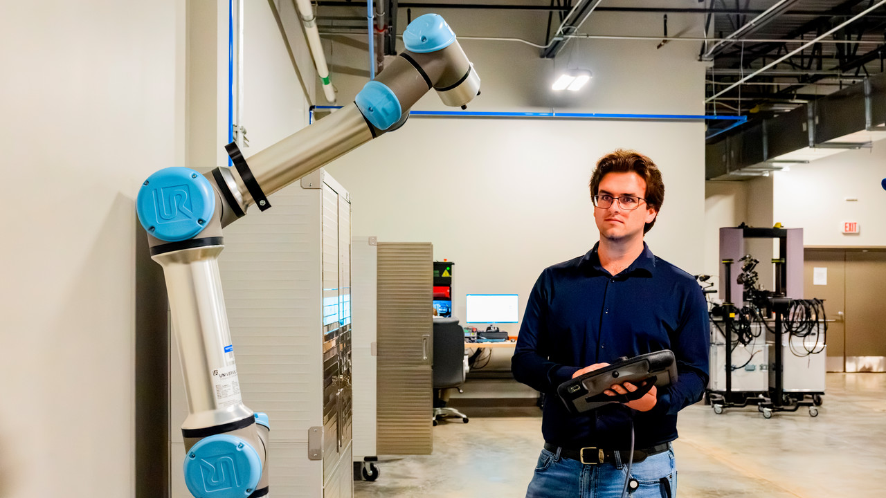 engineer working with robotic arm